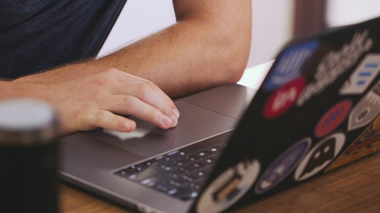 Person cleaning laptop