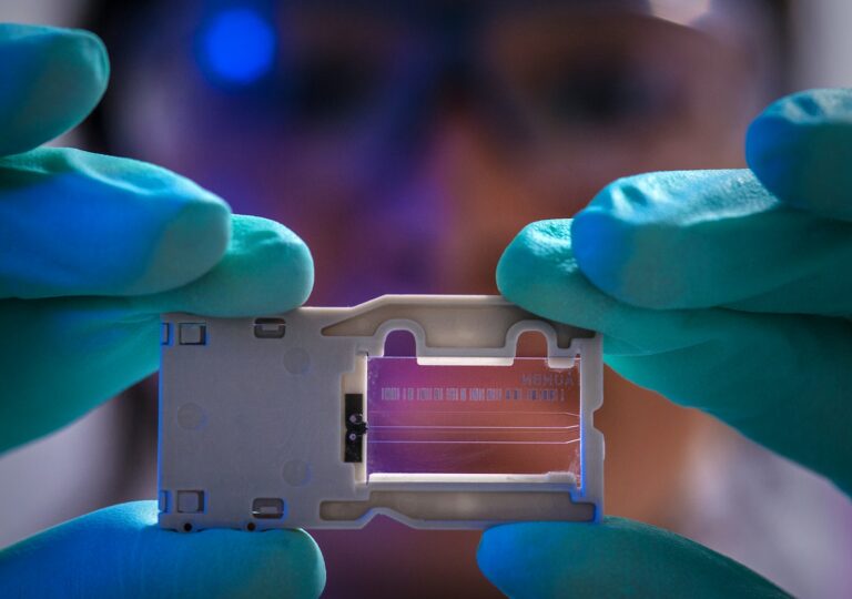 Scientist holding microfluidic