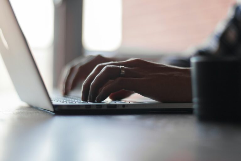 Hand typing laptop
